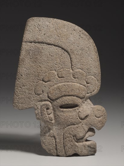 Ballgame Thin Stone Head (Hacha), 600-900. Mexico, Gulf Coast, Classic Veracruz style (600-1100). Stone, pigment traces; overall: 23.7 x 6.9 x 15.8 cm (9 5/16 x 2 11/16 x 6 1/4 in.).