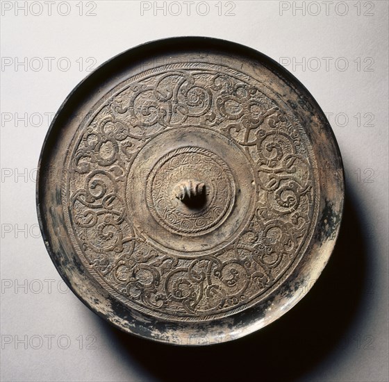 Mirror with Serpentine Interlaces, early 5th-late 3rd century BC. China, Eastern Zhou dynasty (771-256 BC), Warring States period (475-221 BC). Bronze; diameter: 18.2 cm (7 3/16 in.); overall: 1 cm (3/8 in.); rim: 0.8 cm (5/16 in.).