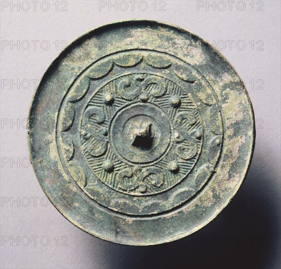Mirror with Four Dragons Pattern, 5th-3rd Century BC. China, Eastern Zhou dynasty (771-256 BC), Warring States period (475-221 BC). Bronze; diameter: 8.5 cm (3 3/8 in.).