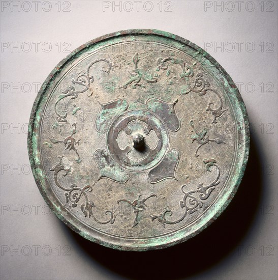 Mirror with Double Quatrefoils, Dragons, and Phoenixes, 3rd century BC. China, Eastern Zhou dynasty (771-256 BC), Warring States period (475-221 BC). Bronze; diameter: 23.2 cm (9 1/8 in.); overall: 1.2 cm (1/2 in.); rim: 0.5 cm (3/16 in.).