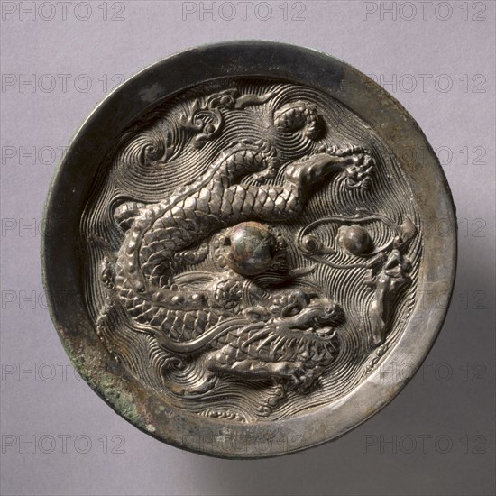 Dragon Mirror, mid 14th Century - mid 17th Century. China, Ming dynasty (1368-1644). Bronze; diameter: 14.1 cm (5 9/16 in.); overall: 1.3 cm (1/2 in.); rim: 1 cm (3/8 in.).