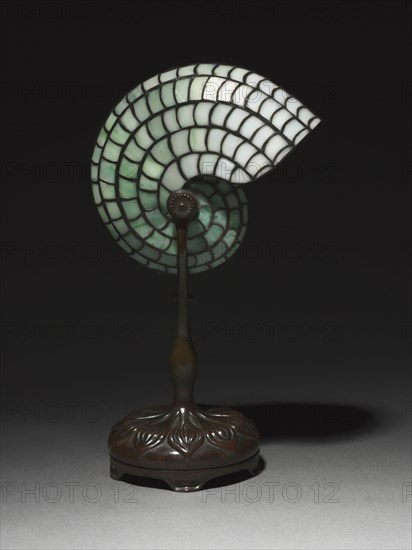 Desk Lamp, c. 1900. Studio of Louis Comfort Tiffany (American, 1848-1933). Bronze, leaded glass; overall: 34.5 x 21.3 x 13.4 cm (13 9/16 x 8 3/8 x 5 1/4 in.).