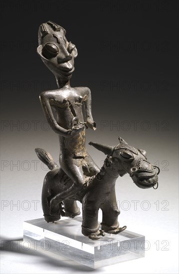 Equestrian Figure, possibly 1700s. Guinea Coast, Nigeria, Yoruba, possibly 18th century. Copper alloy; with base: 34.3 x 10.8 x 25.4 cm (13 1/2 x 4 1/4 x 10 in.); without base: 31.3 x 10.8 x 25.4 cm (12 5/16 x 4 1/4 x 10 in.)