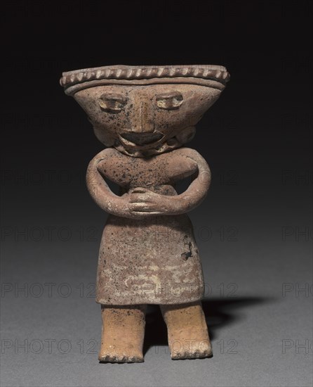 Standing figurine holding an animal (dog?), 300 B.C. to A.D. 300. West Mexico, Colima or Jalisco state, possibly Tuxcacueso-Ortices municipality, 300 B.C. to A.D. 300. Ceramic and pigment; overall: 16 x 8 cm (6 5/16 x 3 1/8 in.).