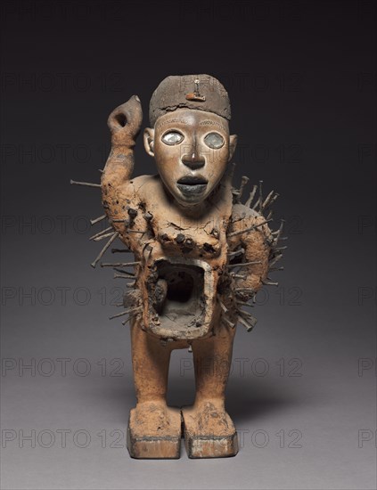 Male Figure, late 1800s-early 1900s. Central Africa, Democratic Republic of the Congo or Cabinda, probably Kongo people. Wood, mirror, iron, mud, ivory or plastic; overall: 46 x 25.7 x 19.2 cm (18 1/8 x 10 1/8 x 7 9/16 in.)