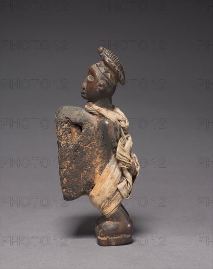 Male Figurine, late 1800s-early 1900s. Central Africa, Democratic Republic of the Congo (most likely), Cabinda, or Republic of the Congo, probably Yombe people. Wood with fabric; overall: 17 x 5.3 x 7 cm (6 11/16 x 2 1/16 x 2 3/4 in.)