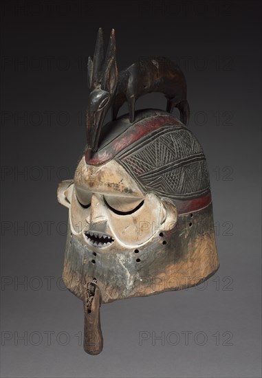 Helmet Mask, late 1800s-early 1900s. Central Africa, Democratic Republic of the Congo, Suku people. Wood, basketry reed, metal; overall: 50 x 25 x 27.2 cm (19 11/16 x 9 13/16 x 10 11/16 in.)