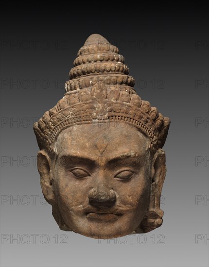 Colossal Head of a Deva, c. 1200. Cambodia, Angkor, c. early 13th century. Sandstone; overall: 71.3 x 50 x 47 cm (28 1/16 x 19 11/16 x 18 1/2 in.).