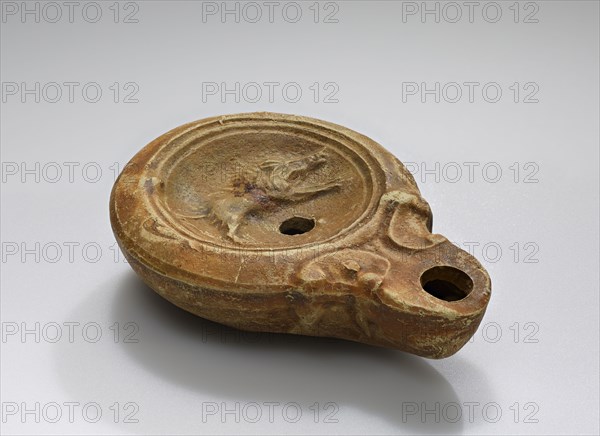Lamp, Roman Empire; 1st century B.C. - 4th century A.D; Terracotta; 9.2 x 2.6 x 6.7 cm, 3 5,8 x 1 x 2 5,8 in