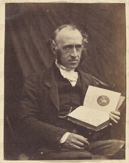 Portrait of Seated Man with a Book; British; 1870 - 1875; Albumen silver print