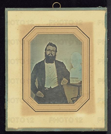 Portrait of a Bearded Man Wearing Wire-Rimmed Glasses seated next to a Bust of Voltaire by Houdon; French; July 28, 1843