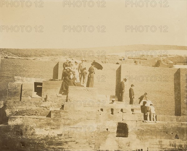 Men and women standing on steps of ruin; about 1860 - 1880; Tinted Albumen silver print