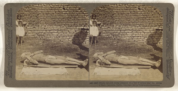 Hindu devotee doing penance on a bed of spikes near the shrine of Kali, Calcutta, India; Underwood & Underwood, American, 1881