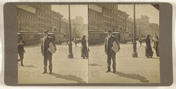Man on street with stack of newspapers under his arm, Albany, N.Y; Julius M. Wendt, American, active 1900s - 1910s, 1900s