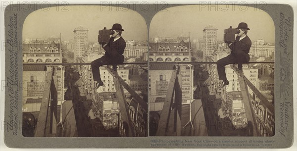 Photographing New York City - on a slender support 18 stories above pavement of Fifth Avenue; Underwood & Underwood, American