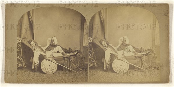 Young soldier asleep on a couch, helmet, sword, and shield in hands; about 1860; Albumen silver print