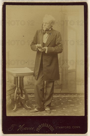 A Game of Cards, actor holding playing cards, standing; Theophile W.M. Havee, American, 1848 - 1921, active Stamford
