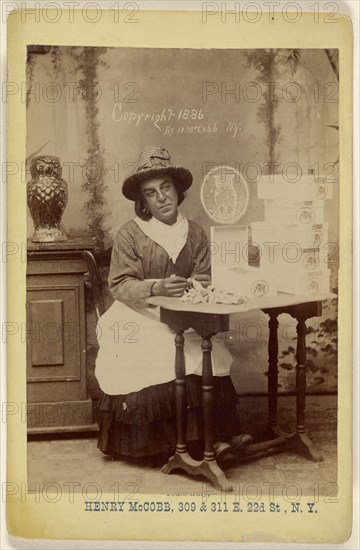 man dressed as a woman seated at a table wrapping chocolates; Henry McCobb, American, active New York, New York 1880s, 1886