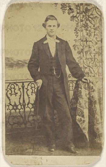well-dressed man holding a walking stick; about 1868; Albumen silver print