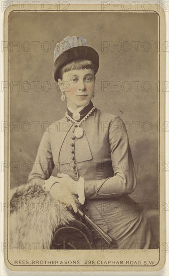 woman standing, holding a fan; David Rees & Brother & Son; 1879; Hand-colored albumen silver print