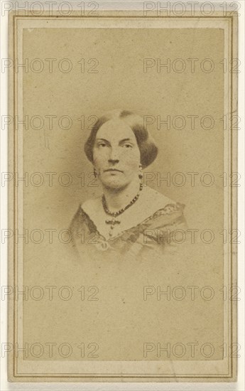 woman wearing a crucifix necklace, printed in vignette-style; J.H. Bostwick, American, active 1860s, 1865 - 1875; Albumen