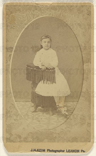 little girl posed on chair with tassels, printed in quasi-oval style; J.H. Keim, American, active 1920s, 1865 - 1870; Albumen