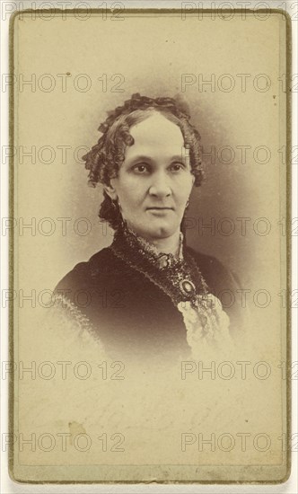 woman with short curly hair, wearing a cameo, printed in vignette-style; Beer & Company; 1870 - 1875; Albumen silver print