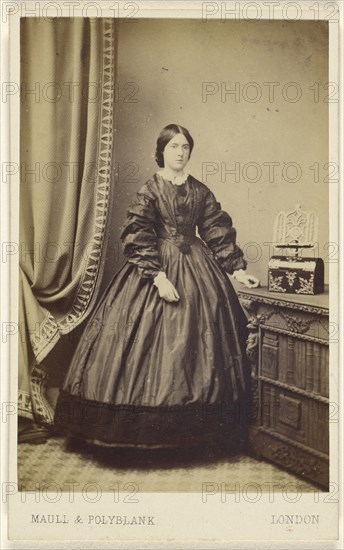 woman wearing a long dress, standing; Maull & Polyblank, British, active 1850s - 1860s, 1862 - 1865; Albumen silver print