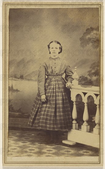 young woman in a studio setting, standing; 1865 - 1870; Albumen silver print