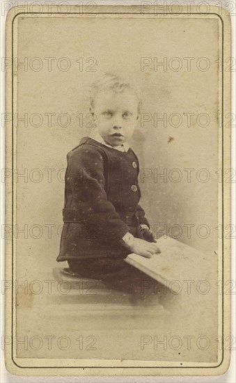 little boy seated with an open book on his lap; John McKean, Scottish, active Leith, Scotland 1880s - 1890s, 1870 - 1880