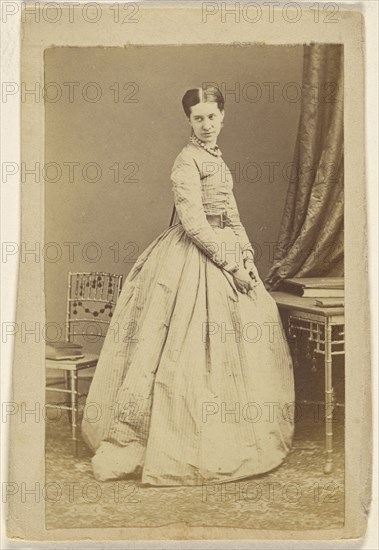 woman wearing a long dress, standing; 1865 - 1870; Albumen silver print