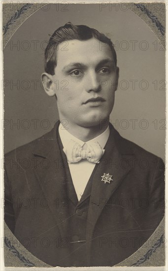 young man wearing a white bow tie and a pin on his lapel; 1875 - 1880; Platinum print