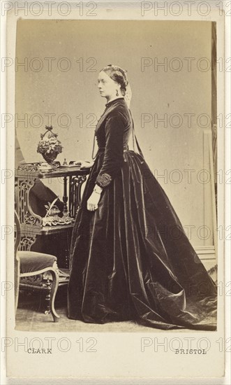 woman wearing a long dress, in profile, standing; William Clark, British, active 1860s, 1865 - 1875; Albumen silver print