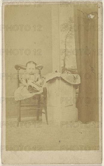 little girl seated with a book in her lap; 1865-1870; Albumen silver print