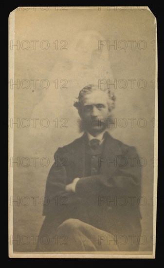 man with muttonchops seated with arms crossed, a female  spirit  in the background; Attributed to William H. Mumler, American