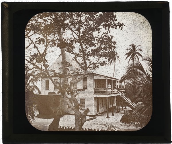 Belize City, ADLP standing on porch of two story white house, Belize City, Augustus and Alice Dixon Le Plongeon papers, 1763
