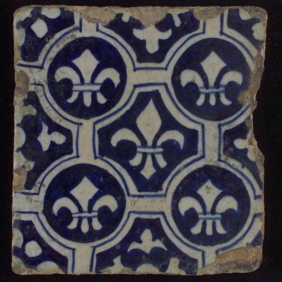 Two-tone tile, blue on white background, four circles with white French lily around central ornament with lily, wall tile