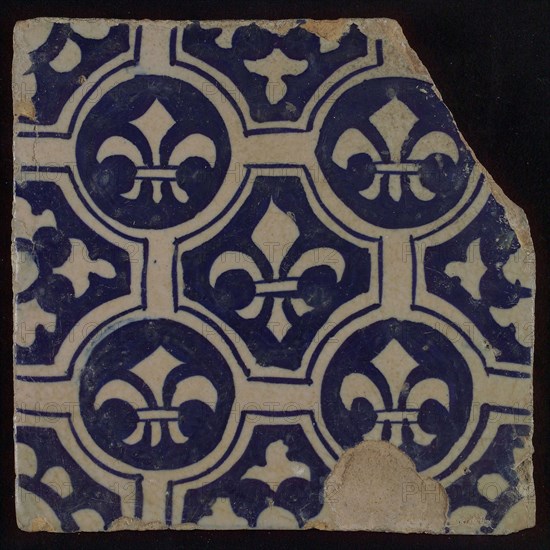 Two-tone tile, blue on white background, four circles with white French lily around central ornament with lily, wall tile