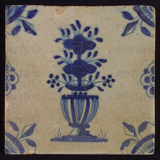 Tile, flowerpot in blue on white, corner motif spotted quarter rosette with lily, half rosette on left and right side, flowed