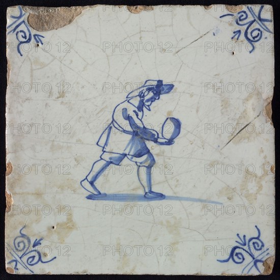 Occupation tile, blue with man who is bolting, corner motif ox's head, wall tile tile sculpture ceramic earthenware glaze, baked