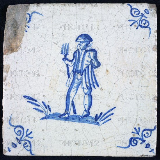 Figure tile, blue with soldier (warrior) with trident on ground, corner pattern ox head, wall tile tile sculpture ceramic