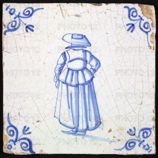 Figure tile, blue with lady with big hat, seen on the back, corner motif ox's head, wall tile tile sculpture ceramic earthenware