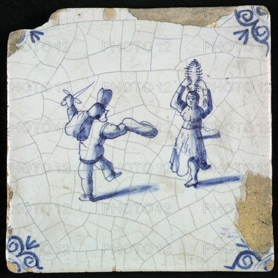 Figure tile, blue with dancing couple, man has sword, the woman holds branches or feathers above her head, corner pattern ox