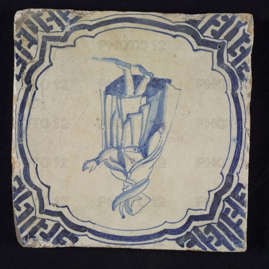 Figure tile, blue with nobleman with big hat and long coat, in scalloped frame with braces, corner motif meander, wall tile