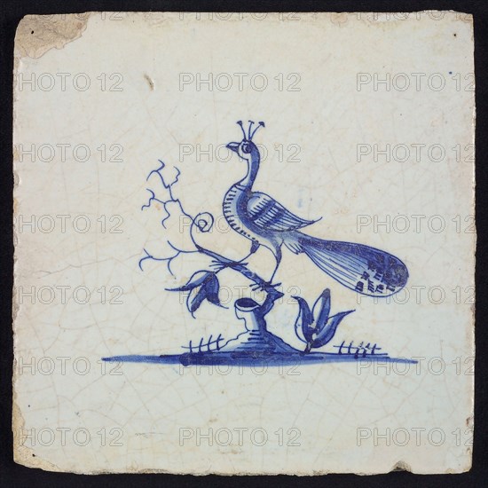 Animal tile, bird on branch on the ground to the left, blue on white, no corner pattern, wall tile tile sculpture ceramic