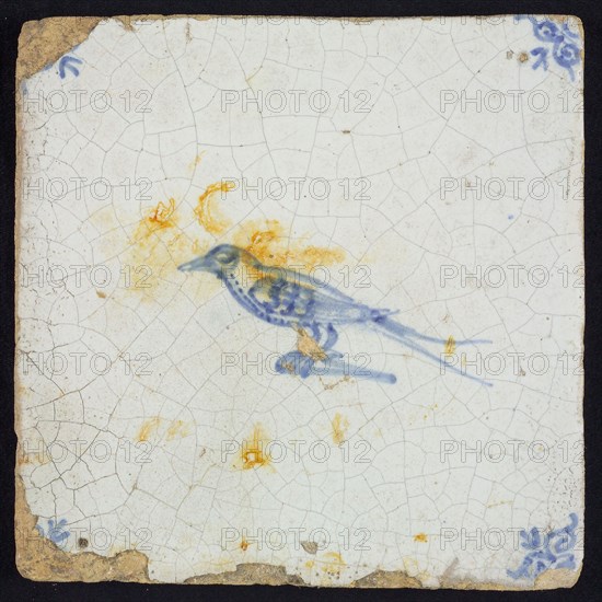 Animal tile, bird on ground to the left, in blue on white, corner motif of ox's head, wall tile tile sculpture ceramic