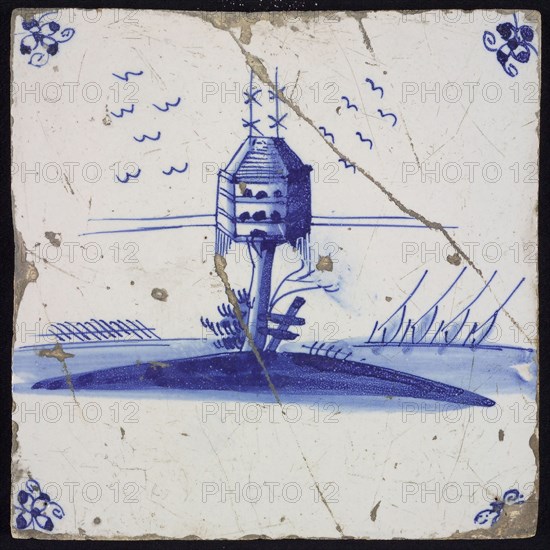 Scene tile, blue with landscape with hexagonal dovecote on tree trunk, corner pattern spider, wall tile tile sculpture ceramic