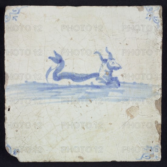 Sea creature tile, bovine with horns and curled fish tail in running water to the right, in blue on white, corner motif oxen