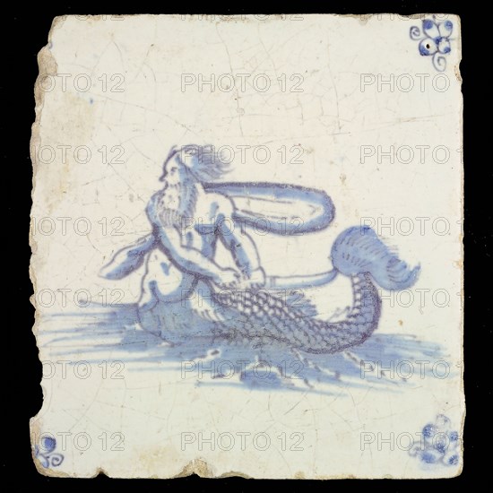 Sea creature tile, in blue on white, naked man with fish tail in water to the left, in hand saber, corner motif spider, wall
