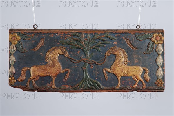 Wooden painted back plate of farm wagon, with image two gilded horses tied to tree, back crate wood carving sculpture footage